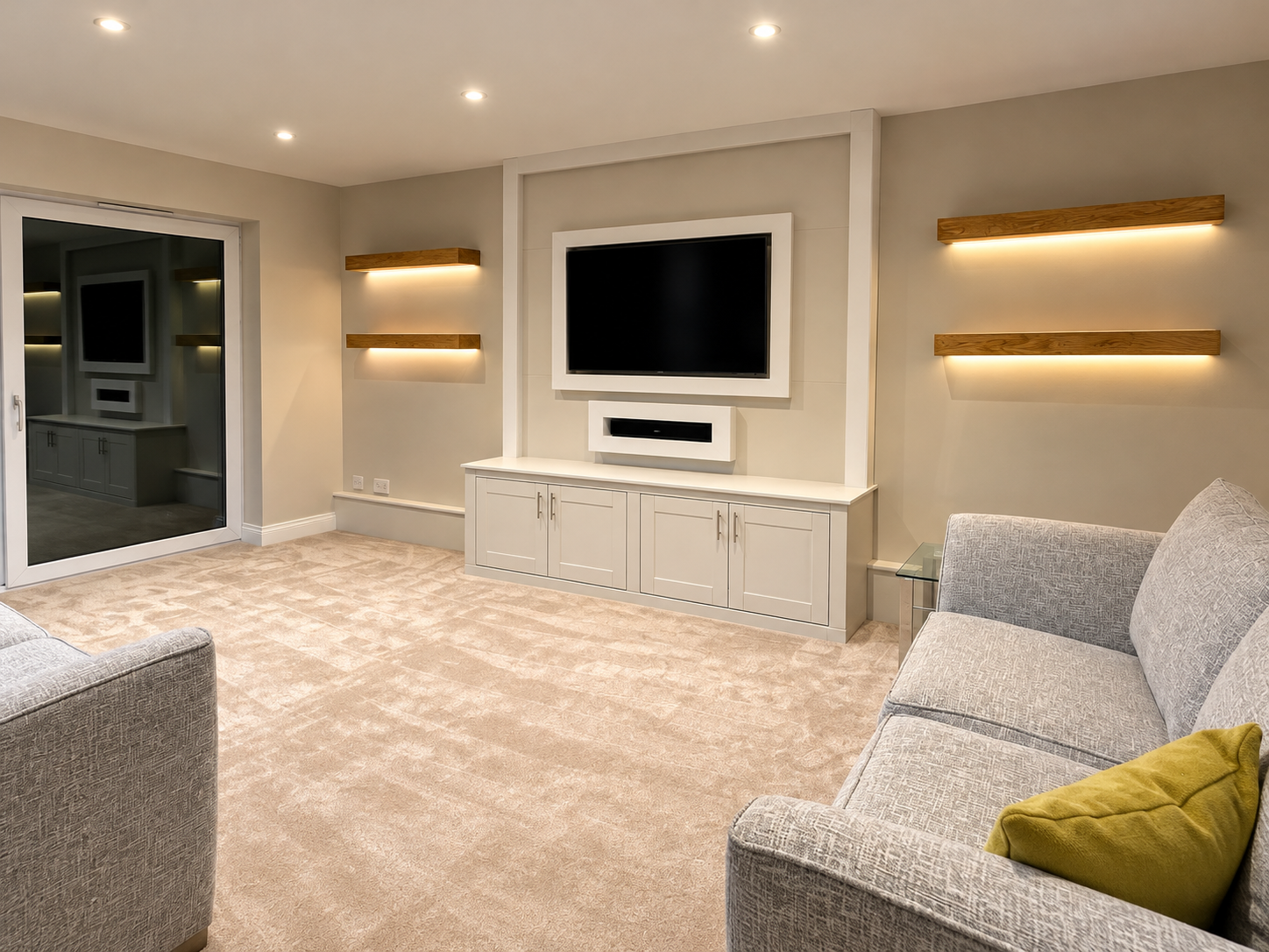 Modern lounge with a painted media wall around the TV, oak floating shelves and soft carpet